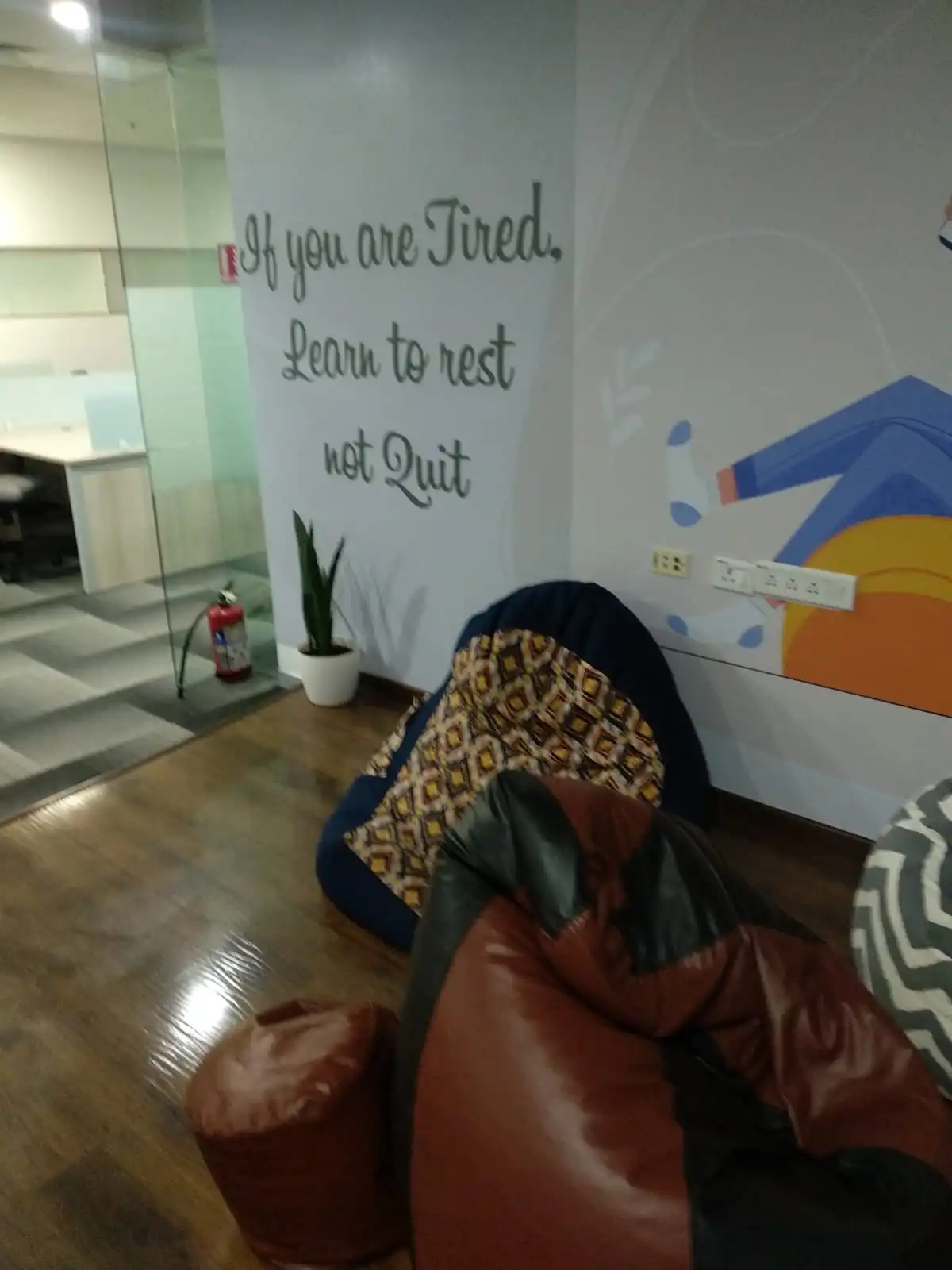 Office wall with the quote If you are tired learn to rest not quit